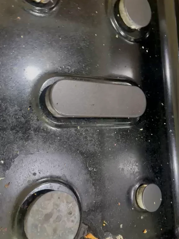 Stovetop before cleaning, covered in spills, crumbs and burnt-on grease